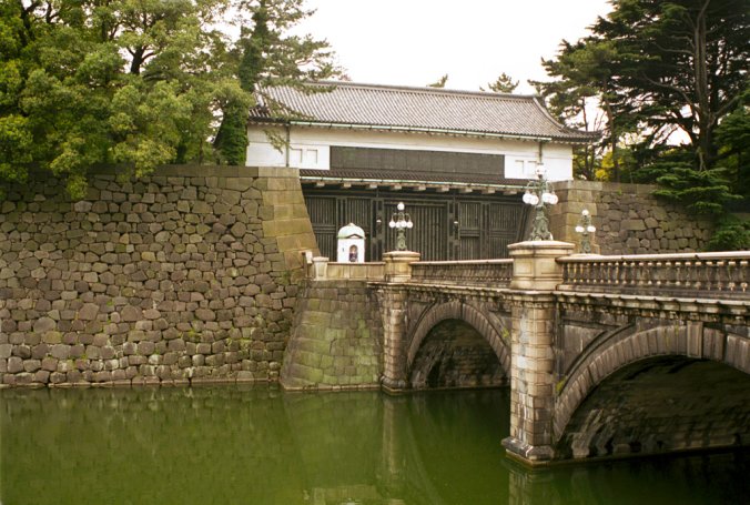 Another gate of the Imperial Palace in Tokyo, over a bridge and with two guards.